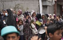 Palestinians line up for food distribution in Deir al Balah, Gaza, Friday, May 10, 2024.