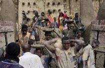 Malians take part in the annual replastering of the world's largest mud-brick building, the Great Mosque of Djenne, Mali, Sunday, May 12, 2024. 