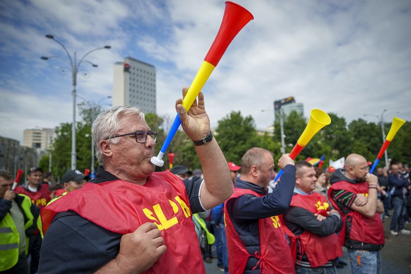 Trade union members from across the country take part in a protest outside government headquarters in Bucharest, May 13, 2024