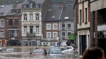 Autos stehen fast unter Wasser, als das Hochwasser eine Hauptstraße in Pepinster, Belgien, am Donnerstag, 15. Juli 2021, hinunterfließt. 