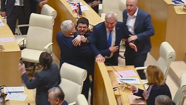 This photo taken from video, released by Mtavari Channel on Tuesday, May 14, 2024, shows Georgian lawmakers fighting during a parliament session in Tbilisi, Georgia.