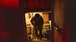 A Ukrainian serviceman of the ACHILLES battalion of the 92nd brigade carries a suicide drone before flying it over Russian positions in the Kharkiv region of Ukraine on Sunday