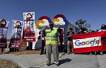 Demonstrators hold signs in protest as they block an entrance to the Google I/O conference in Mountain View, Calif. on Tuesday, May 14, 2024. 