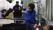 Palestinian medics treat a wounded person as the other one carries a young wounded in the Israeli bombardment of the Gaza Strip at the Kuwaiti Hospital in Rafah refugee camp, 