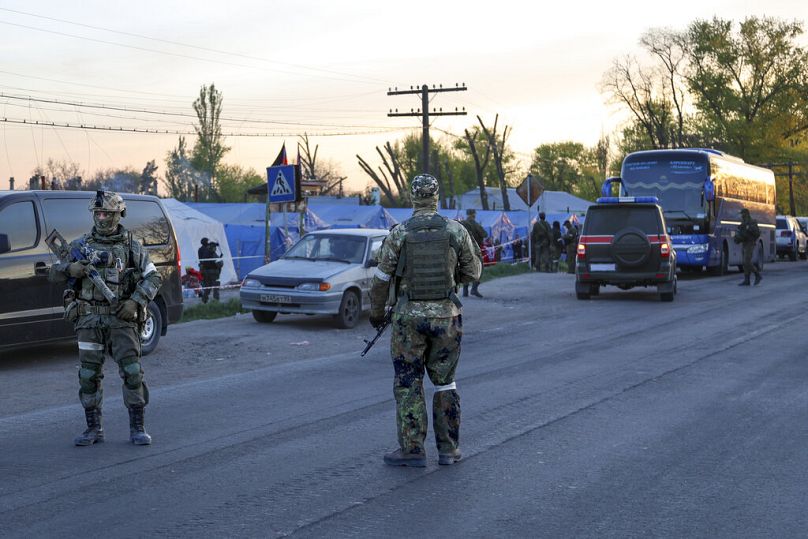 Russian forces guard the camp where local residents who left a shelter in the Metallurgical Combine Azovstal and are temporarily staying in Bezimenne.