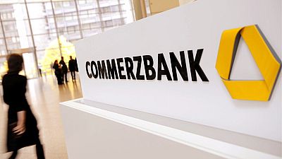 In this Dec. 4, 2011 file picture a person passes the logo of German Commerzbank in Frankfurt, Germany.