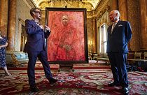 Artist Jonathan Yeo, left, and Britain's King Charles III at the unveiling of Yeo's portrait of the King, in the blue drawing room at Buckingham Palace.