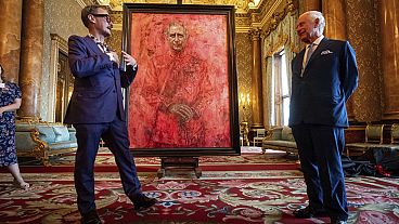 Ο καλλιτέχνης Jonathan Yeo, αριστερά, και ο βασιλιάς της Βρετανίας Κάρολος Γ' στα αποκαλυπτήρια του πορτρέτου του Yeo για τον βασιλιά, στο μπλε σαλόνι του παλατιού του Μπάκιγχαμ.