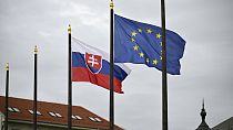 The Slovak national flag, left, flutters next to the flag of European Union in Bratislava