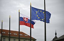 The Slovak national flag, left, flutters next to the flag of European Union in Bratislava