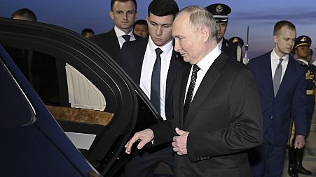 Putin, foreground, gets into a vehicle upon arrival at the Beijing Capital International Airport in Beijing, Thursday, May 16, 2024.