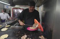 Newly minted Michelin-starred chef Arturo Rivera Martínez prepares an order of tacos at the Tacos El Califa de León taco stand, in Mexico City, Wednesday, May 15, 2024.