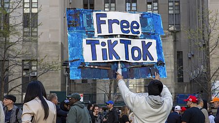 A man carries a Free TikTok sign in front of the courthouse where the hush-money trial of Donald Trump got underway April 15, 2024, in New York.