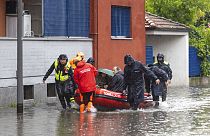 Firefighters use a dinghy boat to evacuate people after part of the city was flooded following persistent rains, in Milan, Italy, Wednesday, May 15, 2024.