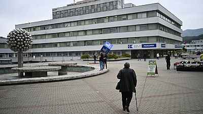 People walk outside the F. D. Roosevelt University Hospital, where Slovak Prime Minister Robert Fico is treated, in Banska Bystrica. Friday, May 17, 2024.