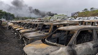 Burnt cars are lined up after unrest in Noumea, New Caledonia.