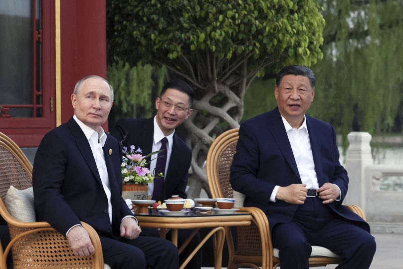 Russian President Vladimir Putin, left, and Chinese President Xi Jinping, right, attend an informal meeting in Beijing.