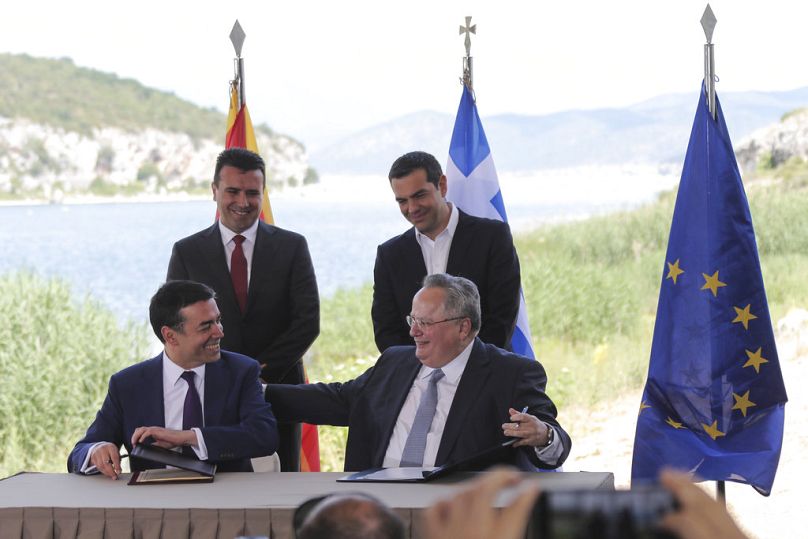 Greek and Macedonian PMs Zoran Zaev and Alexis Tsipras look on as foreign ministers Nikos Kotzias and Nikola Dimitrov sign the Prespa Agreement, 17 June 2018