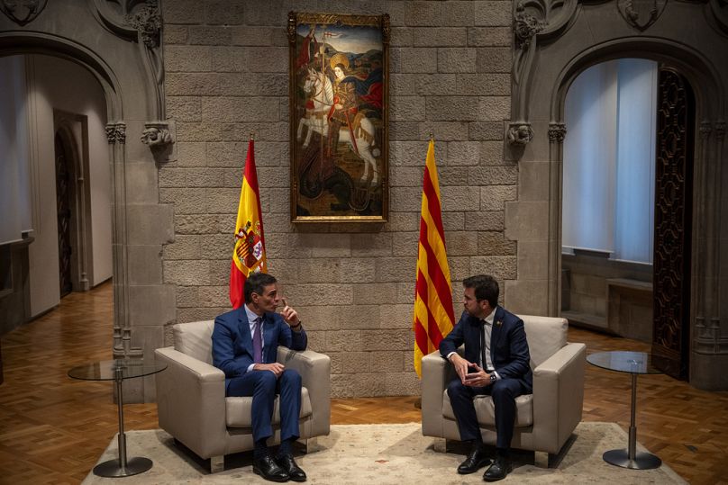Spanish Prime Minister Pedro Sanchez, left, talks with Catalonia's President Pere Aragones during a meeting in Barcelona, Spain, Thursday, Dec. 21, 2023