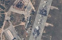 An overview of a destroyed Russian MiG 31 fighter aircraft and fuel storage facility at Belbek air base, near Sevastopol, in Crimea.