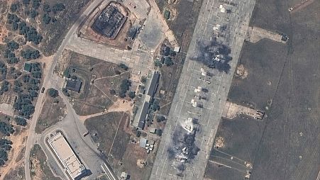 An overview of a destroyed Russian MiG 31 fighter aircraft and fuel storage facility at Belbek air base, near Sevastopol, in Crimea.