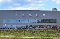Demonstrators walk past the Tesla factory in Gruenheide, Germany, May 11, 2024, at the end of their protest. 