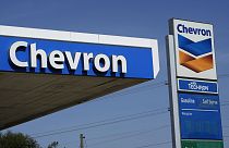 Chevron logos are displayed at a gas station in Columbus, Miss., Monday, Oct. 23, 2023. 