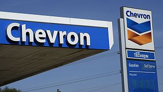 Chevron logos are displayed at a gas station in Columbus, Miss., Monday, Oct. 23, 2023. 