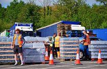People collect bottled water at Broadsands Car Park in Paignton, England, Friday 17 May 2024. 