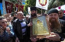 People and Georgian Orthodox Church priests gather to celebrate the Day of Family Purity in front of the Georgian Parliament's building in Tbilisi, Georgia