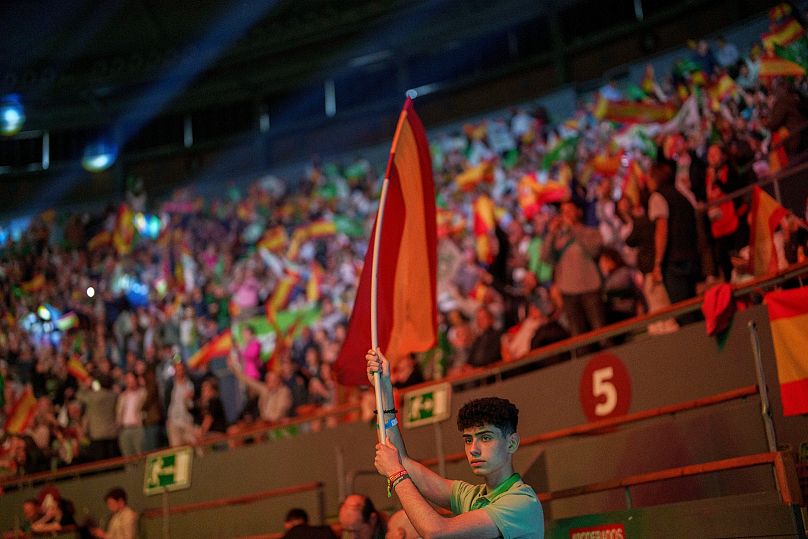 A supporter holds a Spansh flag during the Spanish far-right wing party Vox's rally 'Europa Viva 24' in Madrid, Spain, Sunday, May 19, 2024.