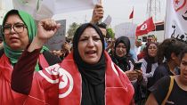 Tunisians take part in a protest against the presence of sub-Saharan migrants who have found themselves stranded in Jebeniana, Tunisia, Saturday, May 18, 2024.