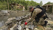 A sapper inspects fragments of Russian missiles that hit a recreation area killing five, and injuring 16, in the outskirts of Kharkiv, Ukraine, Sunday, May 19, 2024. A sapper inspects fragments of Russian missiles that hit a recreation area killing five, and injuring 16, in the outskirts of Kharkiv, Ukraine, Sunday, May 19, 2024.