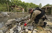 A sapper inspects fragments of Russian missiles that hit a recreation area killing five, and injuring 16, in the outskirts of Kharkiv, Ukraine, Sunday, May 19, 2024.