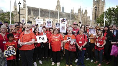 Infected blood campaigners gather in Parliament Square, ahead of the publication of the final report into the scandal, in London.