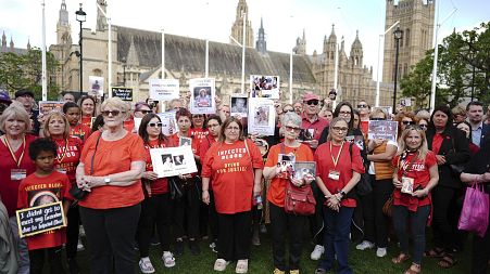 Infected blood campaigners gather in Parliament Square, ahead of the publication of the final report into the scandal, in London.