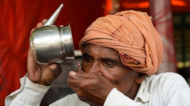 A man drinks water as severe heat grips Lucknow, India, 18 May, 2024.