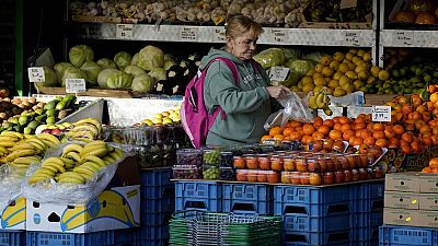 A woman selects fruits at a supermarket in London, on Nov. 17, 2021. 