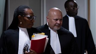 ARCHIVO - El fiscal Karim Khan, en el centro, entra en la sala del tribunal para el juicio de Mahamat Said Abdel Kani en la CPI en La Haya, Países Bajos, el lunes 26 de septiembre de 2022.