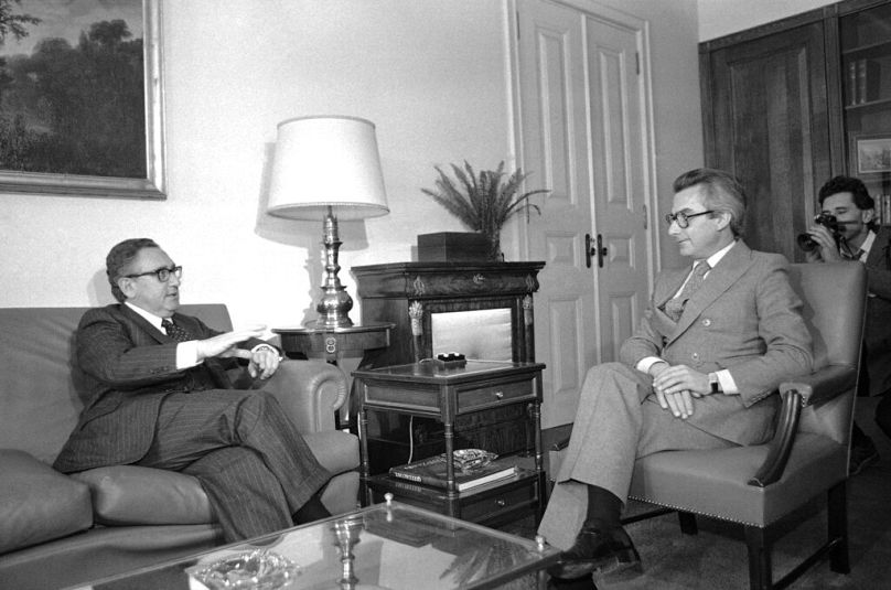 Portuguese Prime Minister Francisco Sa Carneiro, right, discussing U.S.-Portuguese relations with Henry Kissinger in Lisbon , Nov. 15, 1980.