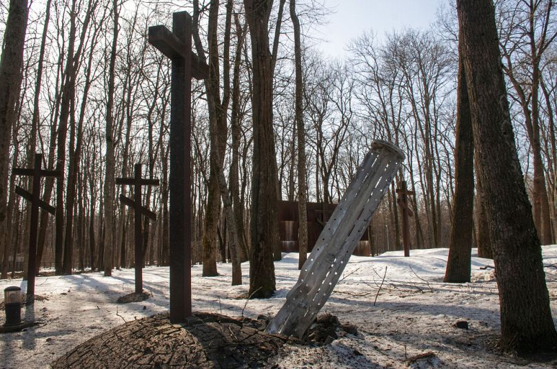 The tail of a rocket sticks out in a memorial for the thousands of Polish officers killed in 1940 by Soviet secret police in the Katyn massacre, in Kharkiv, Ukraine, 23/3/24.