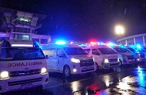 Ambulances wait to carry passengers from a London-Singapore flight that encountered severe turbulence, in Bangkok, Thailand, Tuesday, May 21, 2024. 