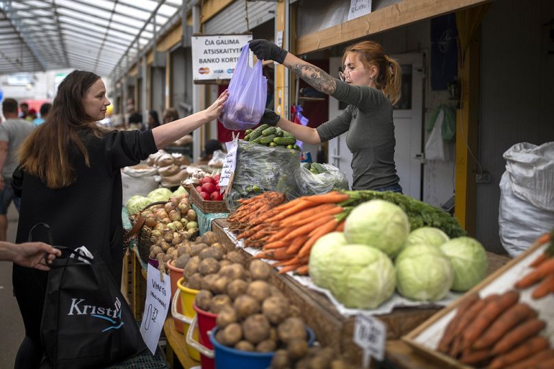 A woman shops vegetables at the bazar in Vilnius, July 2023