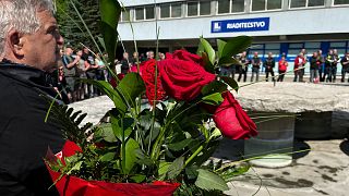 People bring flowers at the F.D Roosevelt hospital, in Banska Bystrica, Slovakia, on May 19, 2024, where Slovak PM Robert Fico is being treated