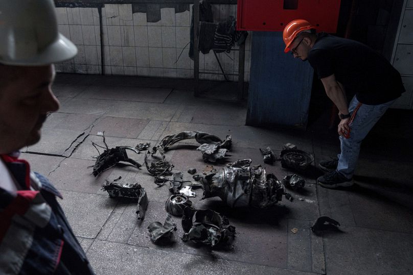 A man looks on fragments of a Russian rocket that hit a thermal power plant in Ukraine, Tuesday, May 21, 2024.
