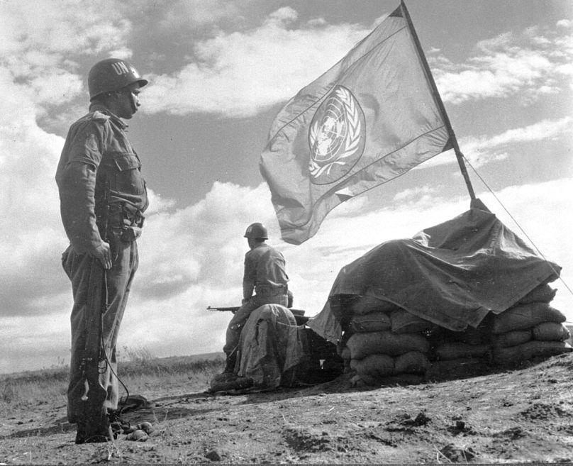 Two soldiers from the United Nations Emergency Forces stand guard at an outpost in the Gaza strip, between Egypt and Israel, 15 November 1957