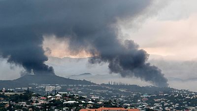 Smoke rises during protests in Noumea, New Caledonia, Wednesday May 15, 2024