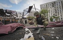 A sapper inspects fragments of a Russian air bomb that hit a living area injuring ten in Kharkiv, Ukraine, Wednesday, May 22, 2024.