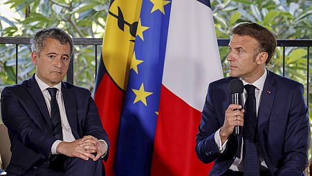 French President Emmanuel Macron sits next to France's Minister for Interior and Overseas Darmanin during a meeting with New Caledonia's elected officials, May 23, 2024.