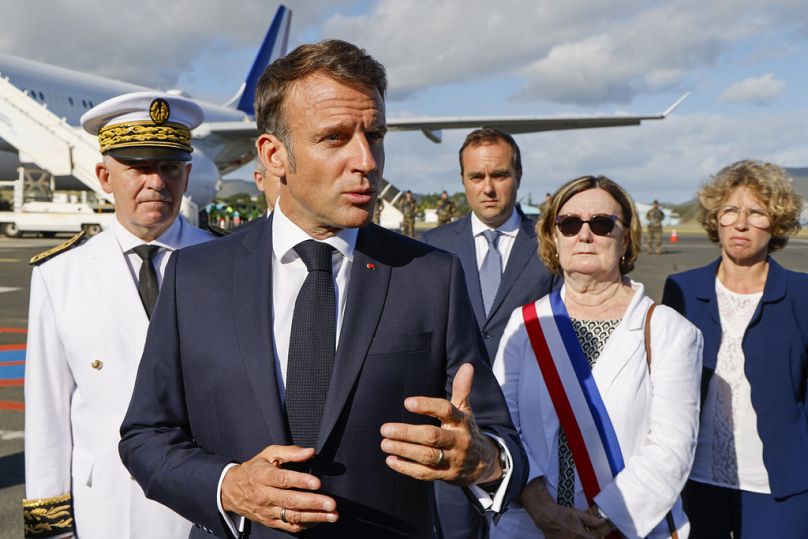 French President Emmanuel Macron speaks with the press upon arrival at Noumea ñ La Tontouta International airport, in Noumea, New Caledonia, Thursday, May 23, 2024.
